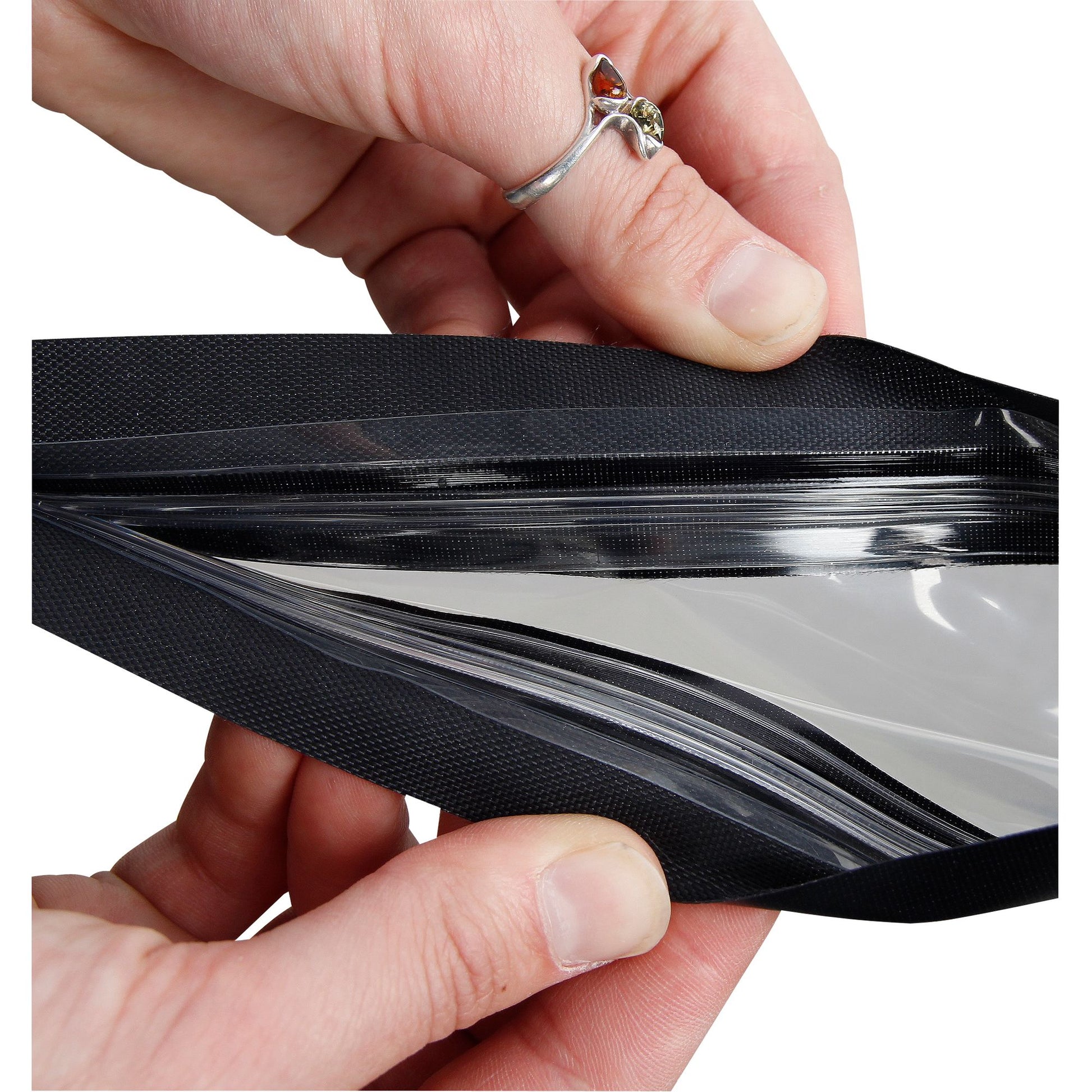 A person is holding a black zippered pouch with a clear urethane window and waterproof closure, called the Hydrolock Map Case by NRS.