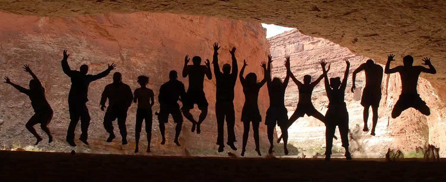 Silhouettes of people in a cave.